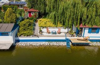 Haus kaufen in 2291 Lassee, LIEBEVOLL GEPFLEGTES TRAUMHAUS AM SEE MIT KAMIN; SEETERRASSE, SOMMERHÄUSCHEN AM WASSERUND GARAGE