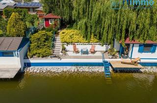 Haus kaufen in 2291 Lassee, LIEBEVOLL GEPFLEGTES TRAUMHAUS AM SEE MIT KAMIN; SEETERRASSE, SOMMERHÄUSCHEN AM WASSERUND GARAGE